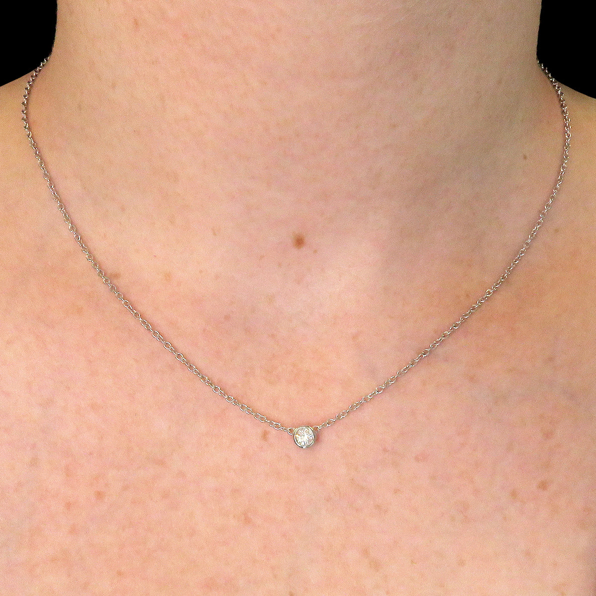 A girl wearing 0.20ct lab grown diamond necklace with 9k white gold