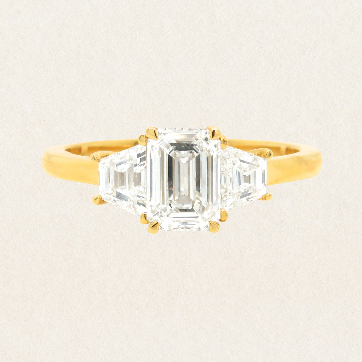 Brilliant emerald cut 1.53ct lab grown diamond trilogy ring made with 18k yellow gold